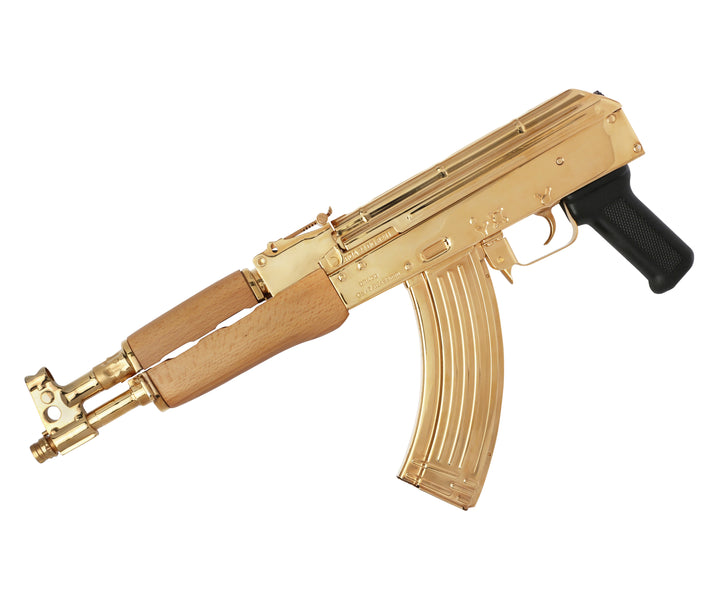 24K Gold Plated Century Arms Draco, high polished to a mirror finish. The Century Arms Draco wraps the AK style into the pistol format. Chambered in 7.62x39mm this semi-automatic pistol has a 12" barrel. While it comes standard with a 30-round magazine the Century Arms Draco is compatible with any AK double stack magazine or drum. The barrel includes an integral front sight and gas tube. SKU: 7783559135334 MFG MODEL NO: HG1916N UPC: 787450044357 DESCRIPTION: Century Arms HG1916N BRAND: Century Arms MODEL: D